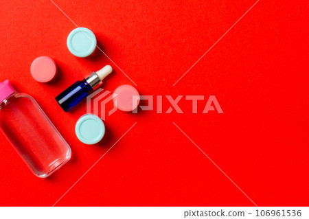 Cosmetics SPA branding mock-up, top view with copy space. set of tubes and jars of cream flat lay on colored background 106961536