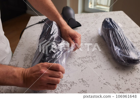 vacuum packing sneakers. for seasonal storage close-up. vacuum packing sneakers. for seasonal storage close-up. 106961648