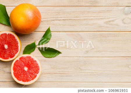fresh Fruit grapefruit with Juicy grapefruit slices on colored background. Top view. Copy Space. creative summer concept. Half of citrus in minimal flat lay with copy space fresh Fruit grapefruit with Juicy grapefruit slices on colored background. Top view. Copy Space. creative summer concept. Half of citrus in minimal flat lay with copy space 106961931