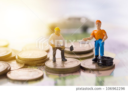 Worker figures working on the coin 106962296
