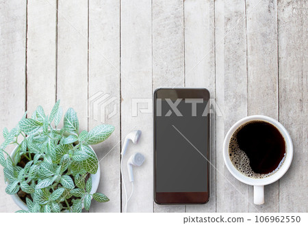 Smart phone and cup of coffee on old wooden background with copy space. 106962550