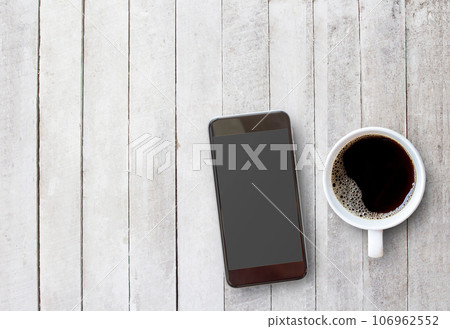 Smart phone and cup of coffee on old wooden background with copy space. 106962552