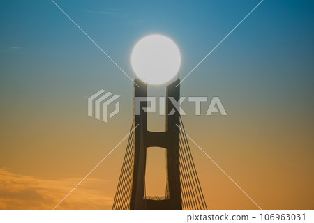 The sunset and the silhouette of the bridge piers. The sunset and the silhouette of the bridge piers. 106963031