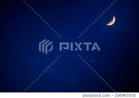 There are moon and stars in the blue sky. Slow exposure photography. 106963058