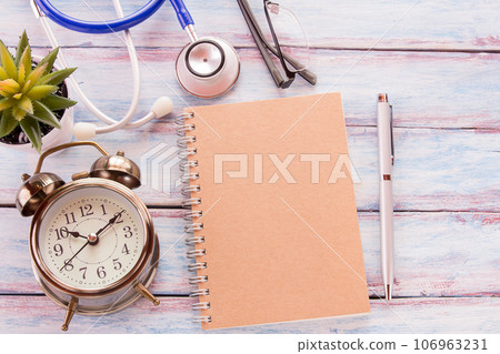 Flat lay photo with blank notebook, pen,blue stethoscope 106963231