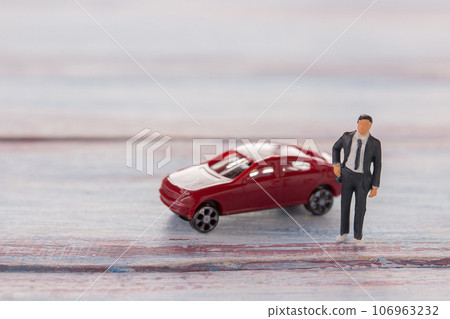 Businessman figures standing on the floor with blurred car Businessman figures standing on the floor with blurred car 106963232