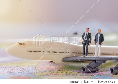 Miniature people - Figure businessmans standing on white airplane model 106963233