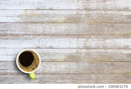 Hot coffee in a green cup on old wooden table Hot coffee in a green cup on old wooden table 106963270
