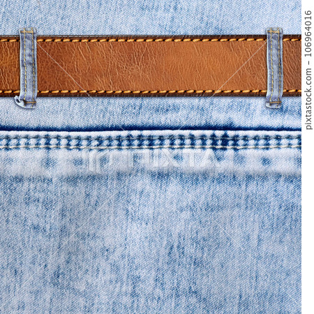 Blue denim background with leather belt. Horizontal or vertical backdrop with light blue color denim jeans fabric texture and brown leather strap. Copy space for text Blue denim background with leather belt. Horizontal or vertical backdrop with light blue color denim jeans fabric texture and brown leather strap. Copy space for text 106964016