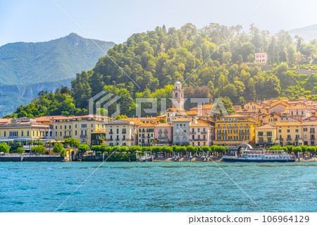 Bellagio town at Como Lake on sunny summer day. Idyllic view from ferry. Lombardy, Italy Bellagio town at Como Lake on sunny summer day. Idyllic view from ferry. Lombardy, Italy 106964129