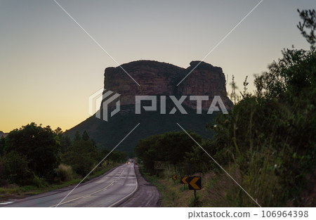 Majestic Silhouette of Father Ignacio's Hill at Dusk with Vehicles on Road 106964398