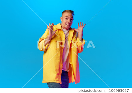 Portrait of handsome man, attractive guy wearing bright casual clothes looks scared, terriefied, afraid. Portrait of handsome man, attractive guy wearing bright casual clothes looks scared, terriefied, afraid. 106965037