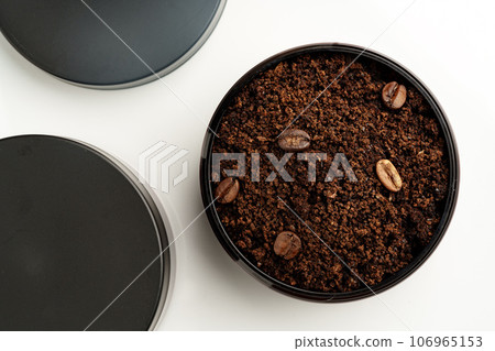 Ground coffee in a plastic container on white background top view Ground coffee in a plastic container on white background top view 106965153