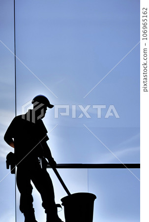 silhouette of worker cleaning exterior windows of skyscrapers silhouette of worker cleaning exterior windows of skyscrapers 106965162
