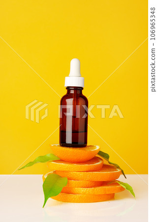 Skincare oil bottle on stacked orange slices Skincare oil bottle on stacked orange slices 106965348