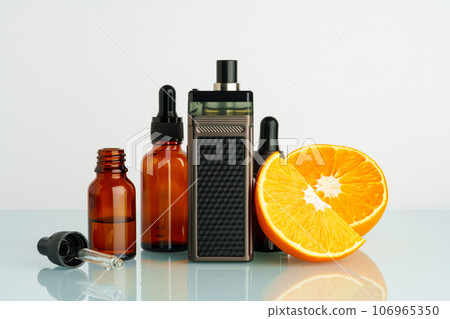 Vape liquid with orange flavor on white background Vape liquid with orange flavor on white background 106965350