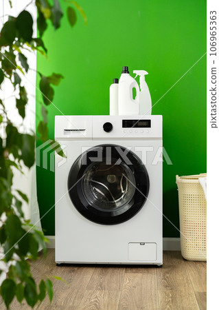 Detergent bottle on washing machine in a laundry room Detergent bottle on washing machine in a laundry room 106965363