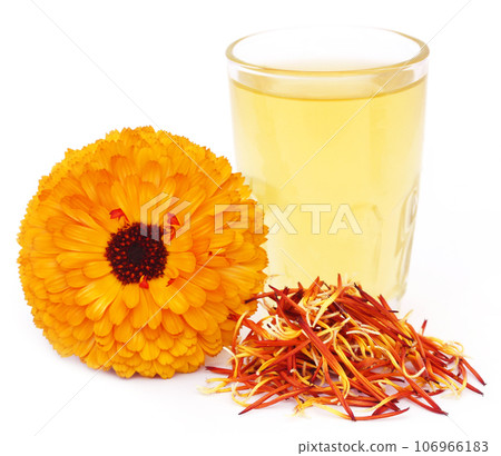 Herbal calendula flower with extract in a glass Herbal calendula flower with extract in a glass 106966183