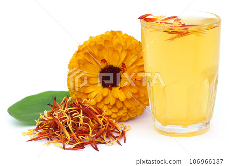 Herbal calendula flower with extract in a glass Herbal calendula flower with extract in a glass 106966187
