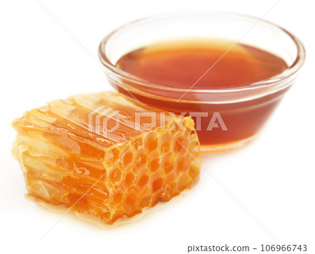 Honey comb with honey in a glass bowl Honey comb with honey in a glass bowl 106966743