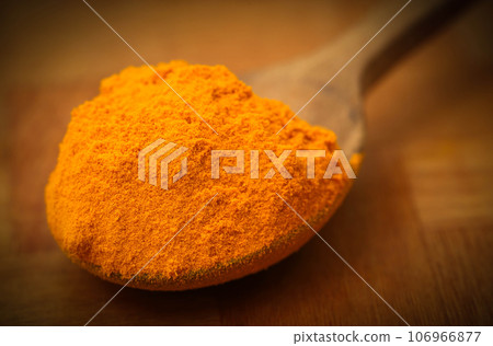 Ground turmeric in a spoon Ground turmeric in a spoon 106966877