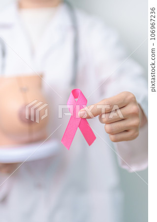 Pink October Breast Cancer Awareness month, doctor woman with pink Ribbon and Breast Anatomy model. National cancer survivors month, health diagnosis, Mother and World cancer day concept Pink October Breast Cancer Awareness month, doctor woman with pink Ribbon and Breast Anatomy model. National cancer survivors month, health diagnosis, Mother and World cancer day concept 106967236