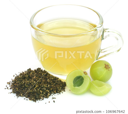 Herbal green tea in a cup with amla fruits Herbal green tea in a cup with amla fruits 106967642