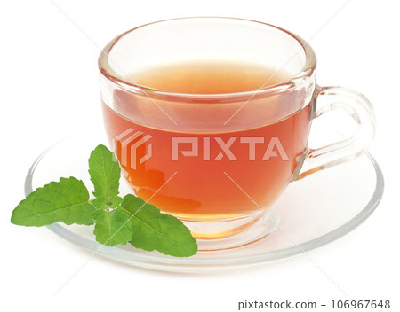 Herbal tea in a cup with tulsi leaves Herbal tea in a cup with tulsi leaves 106967648