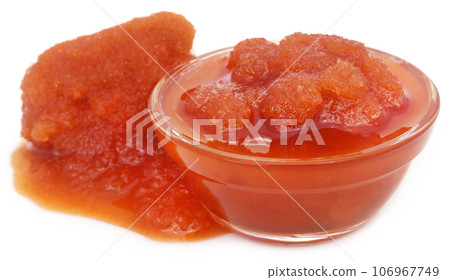 Molasses in a glass bowl over white background 106967749