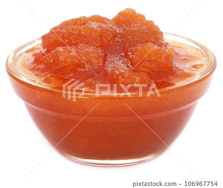 Molasses in a glass bowl over white background 106967754