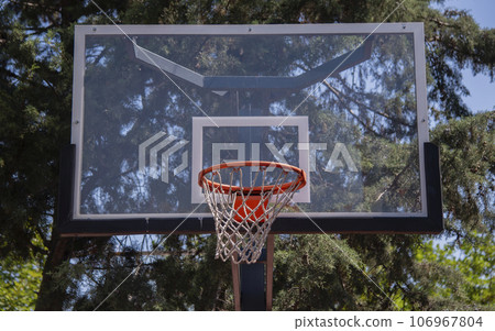 Basketball court outdoors, orange hoop, net and backboard for basket ball game outside in school garden.Turkey,Istanbul 106967804