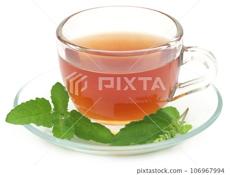 Herbal tea in a cup with tulsi leaves Herbal tea in a cup with tulsi leaves 106967994