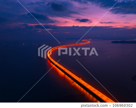 Aerial view of highway light of Penang Second Bridge with dramatic twilight sunset colorful sky background 106968302