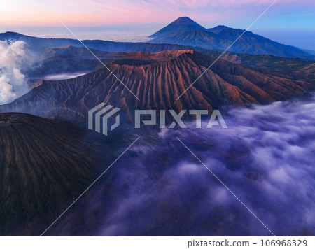 Amazing Mount Bromo volcano during sunrise from king kong viewpoint on Mountain Penanjakan in Bromo Tengger Semeru National Park,East Java,Indonesia.Nature landscape background Amazing Mount Bromo volcano during sunrise from king kong viewpoint on Mountain Penanjakan in Bromo Tengger Semeru National Park,East Java,Indonesia.Nature landscape background 106968329