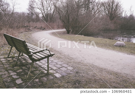 Lonely old wooden bench in a park 106968481