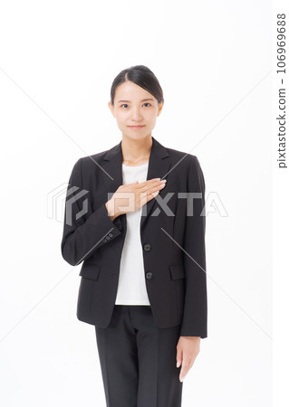 photo of a woman putting her hand on her chest 106969688