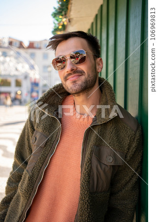 Man wearing sunglasses in city in autumn Man wearing sunglasses in city in autumn 106969813