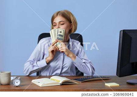 happy blonde business woman cover face money in office 106969841