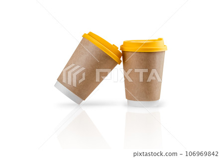 Isolated mockup template of two paper takeaway coffee cups on a white reflective surface. Isolated mockup template of two paper takeaway coffee cups on a white reflective surface. 106969842