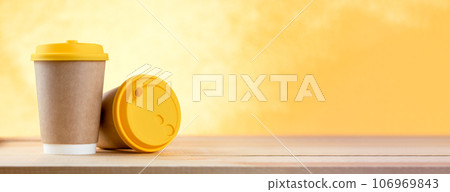 Coffee cups on wood table for food and drink concept. Two take-away coffee cups on the cafe table. 106969843
