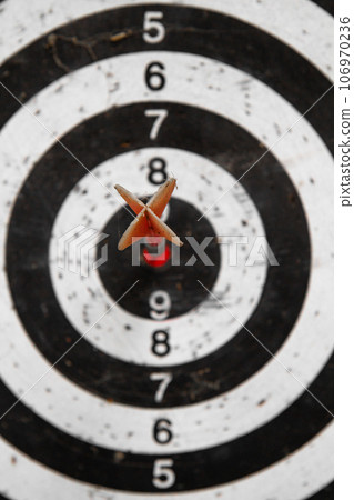 red arrow hitting target right in bullseye red arrow hitting target right in bullseye 106970236