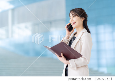 拜訪她的智能手機的年輕女商人在辦公室 106970381