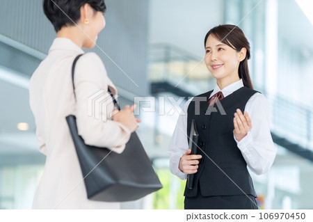 Receptionist guiding a young businesswoman in the office lobby Receptionist guiding a young businesswoman in the office lobby 106970450
