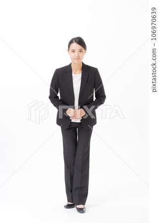 Photo of a woman in a suit standing upright Photo of a woman in a suit standing upright 106970639