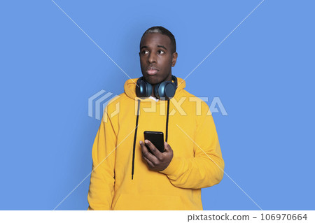 man focused recollecting necessary facts browsing through telephone holding isolated on background man focused recollecting necessary facts browsing through telephone holding isolated on background 106970664