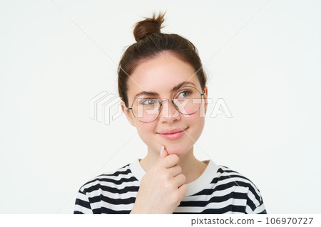 Portrait of pleased and thoughtful face, smiling satisifed, analizing smth, thinking, standing over white background 106970727
