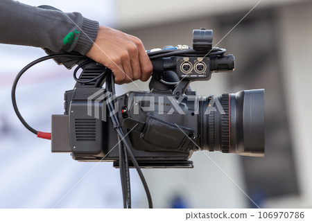 Close up Professional videographer on event, videographer filmmaker cinematographer camera, Filmmaking, videography. Close up Professional videographer on event, videographer filmmaker cinematographer camera, Filmmaking, videography. 106970786