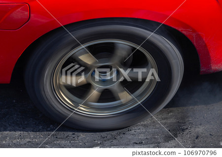 Close up car wheel with smoke on the asphalt road speed track, Car wheel drifting and smoking on track, Car wheel spinning. Close up car wheel with smoke on the asphalt road speed track, Car wheel drifting and smoking on track, Car wheel spinning. 106970796