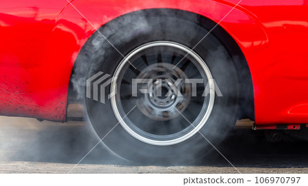 Close up car wheel with smoke on the asphalt road speed track, Car wheel drifting and smoking on track, Car wheel spinning. Close up car wheel with smoke on the asphalt road speed track, Car wheel drifting and smoking on track, Car wheel spinning. 106970797