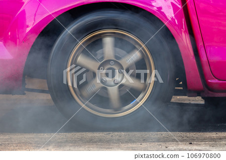 Close up car wheel with smoke on the asphalt road speed track, Car wheel drifting and smoking on track, Car wheel spinning. Close up car wheel with smoke on the asphalt road speed track, Car wheel drifting and smoking on track, Car wheel spinning. 106970800